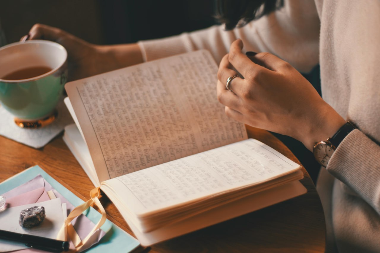 Reviewing a food journal with tea — tracking patterns over time