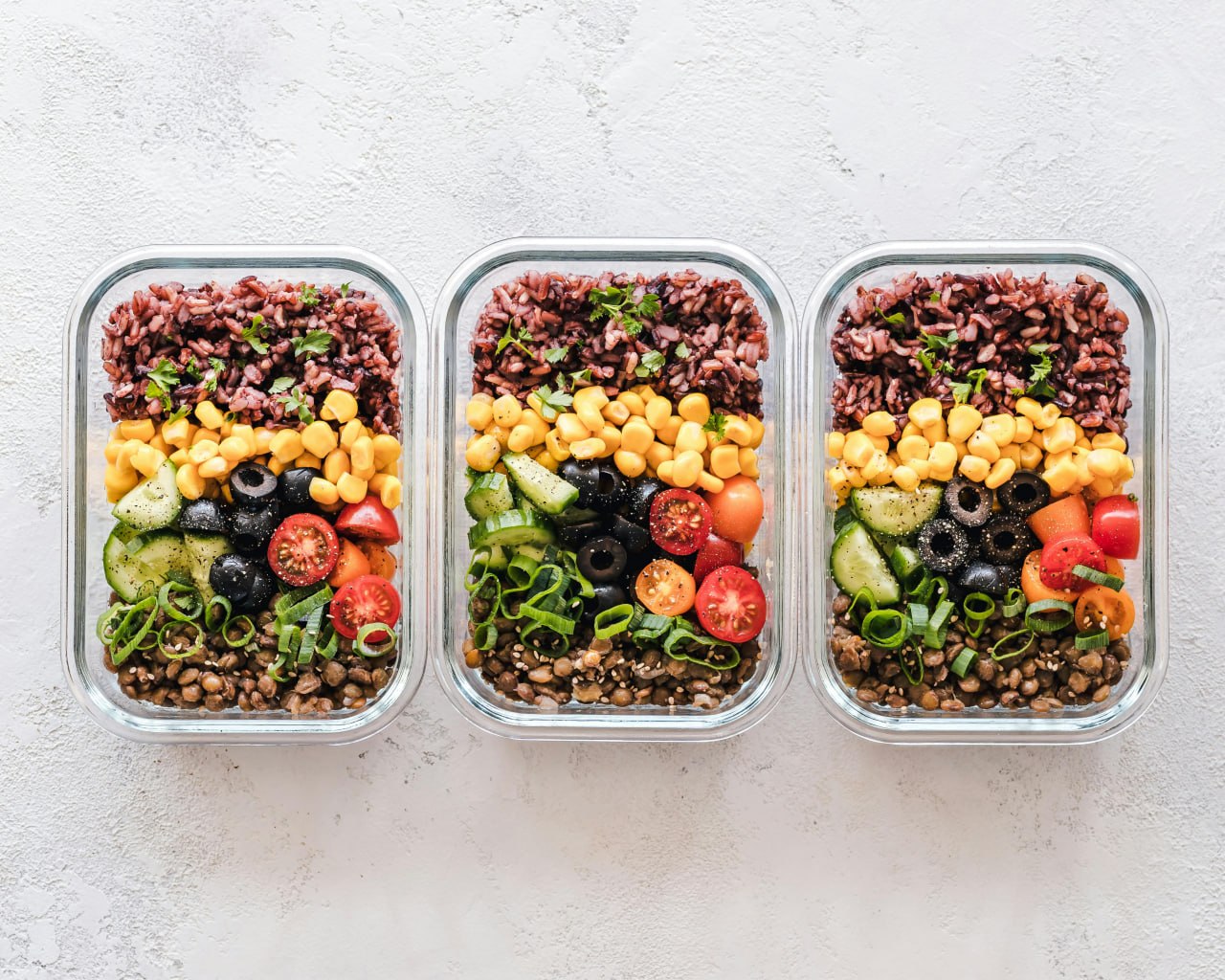 Meal prep containers with rice, vegetables, and legumes — planning makes low-FODMAP easier